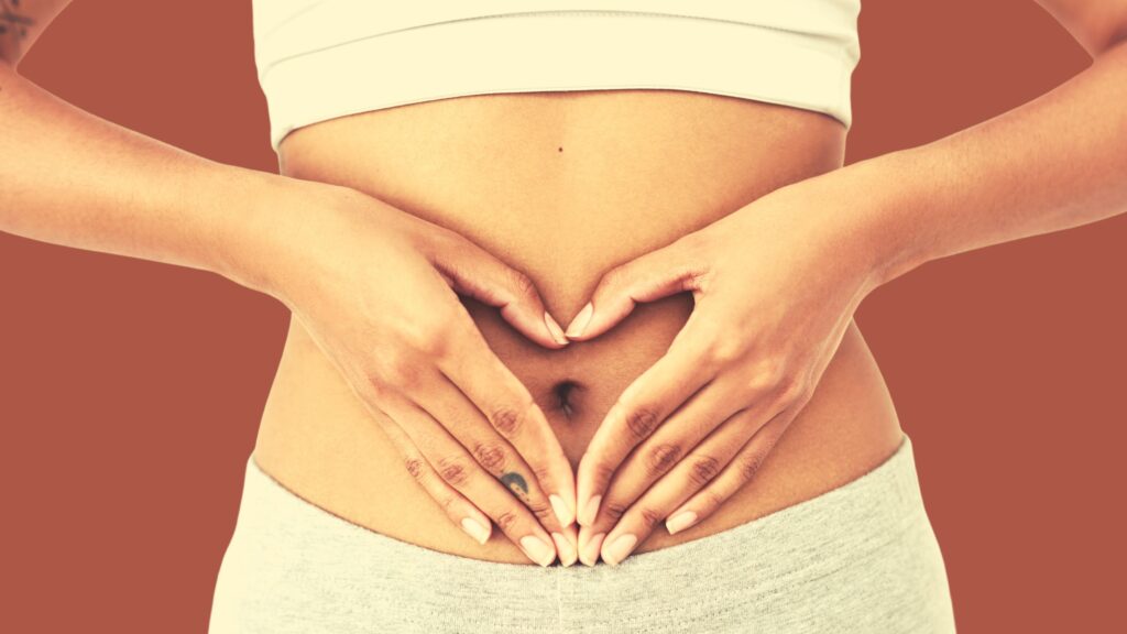 4 Steps to Motivate Yourself with self-compassion featuring a woman making a heart with her hands over her belly button.